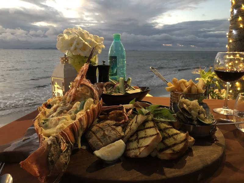 A huge seafood dinner plate with a view of the ocean